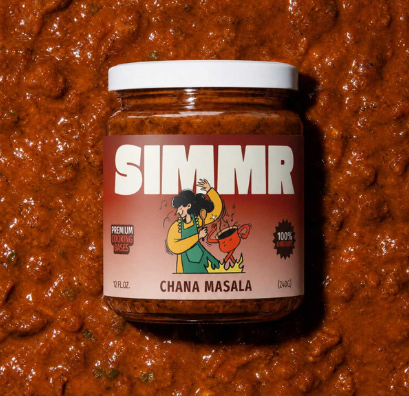 Jar of SIMMR Chana Masala cooking base resting on a bed of its sauce