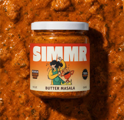 Jar of SIMMR Butter Masala cooking base resting on a bed of its sauce
